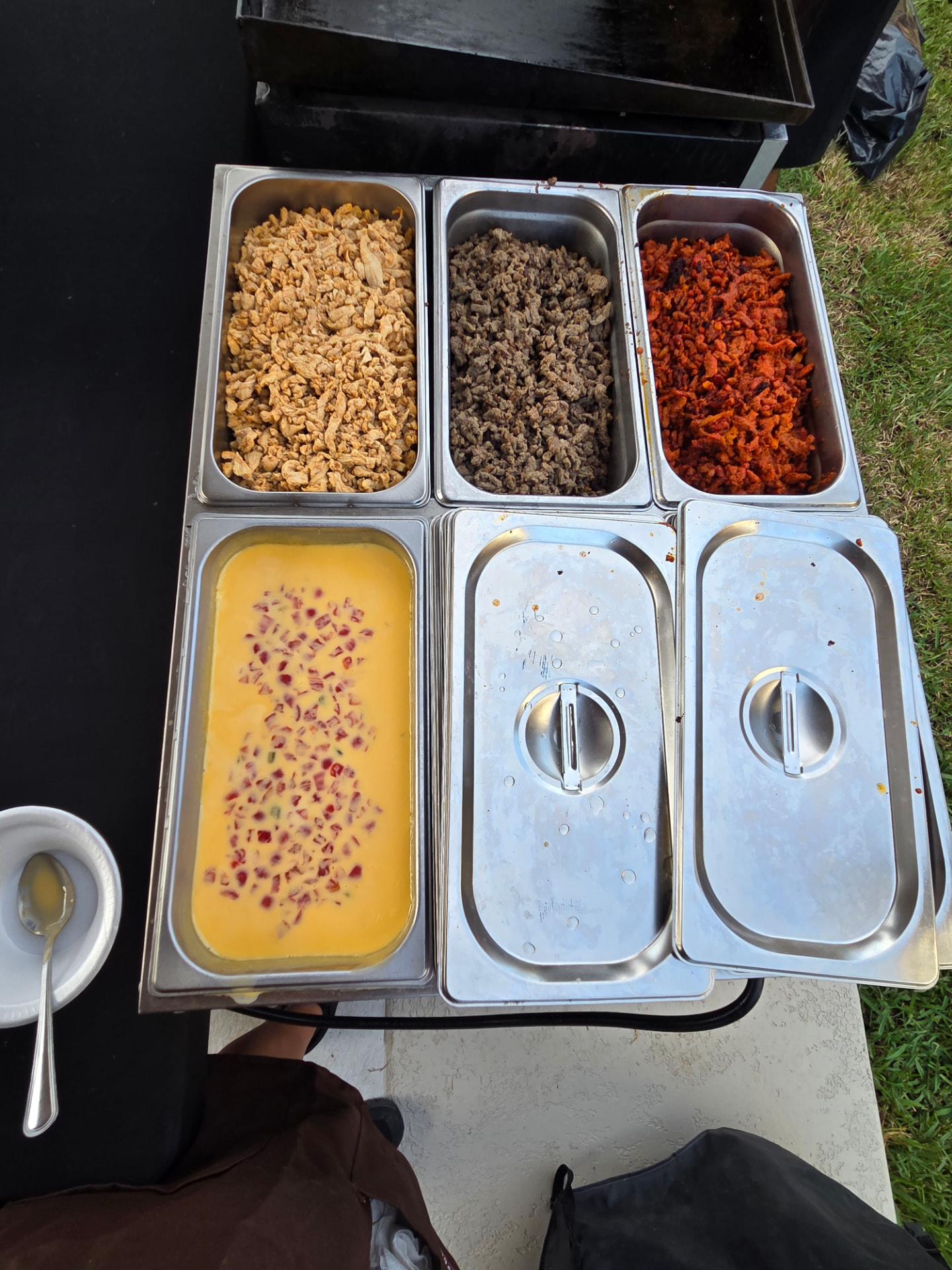 Trays of pollo, carne asada, al pastor and queso