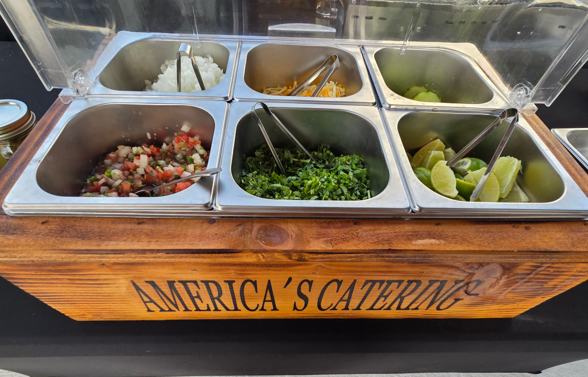 Covered toppings bar with pico de gallo, cilantro and limes